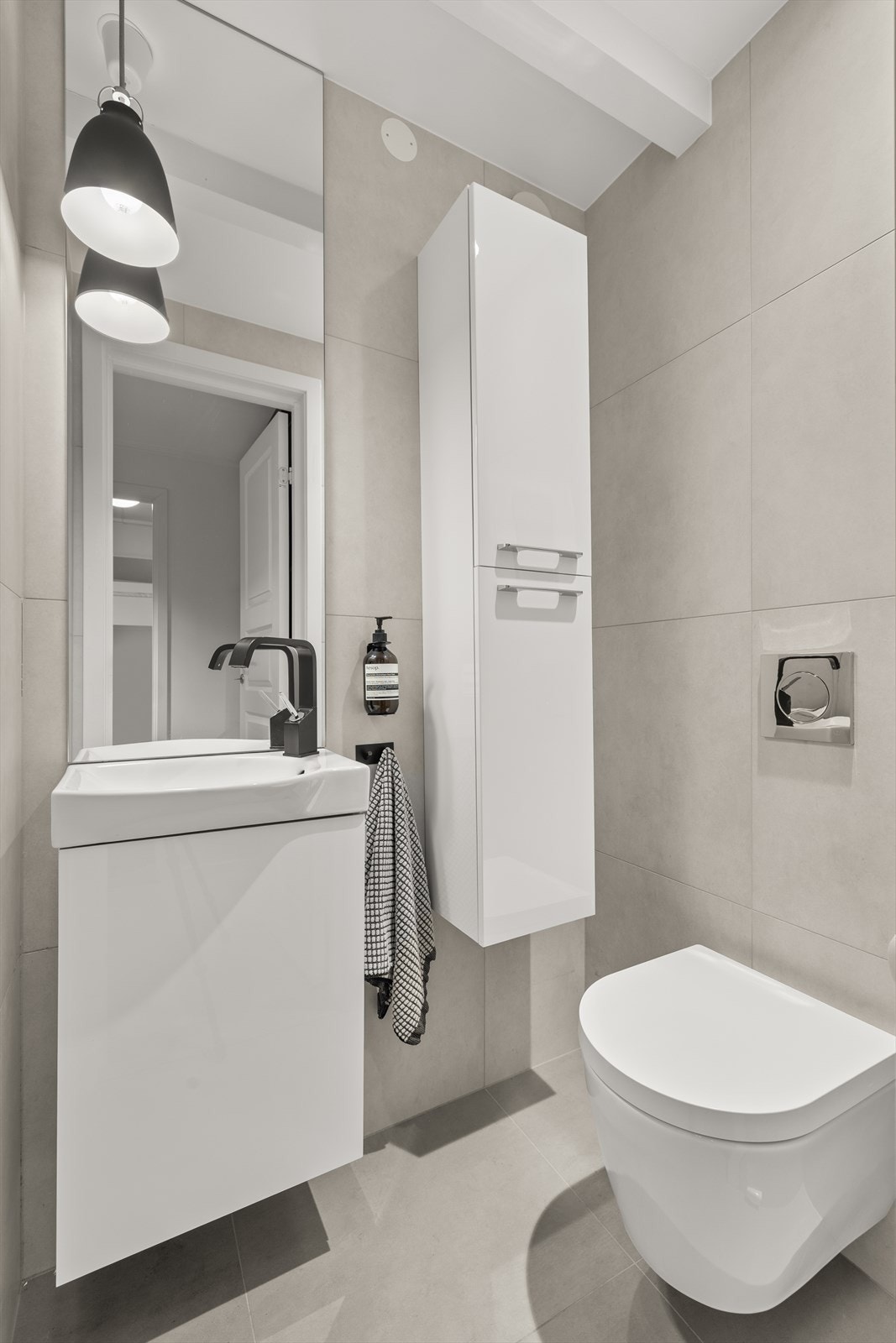 Leiligheten har også egen wc med toalett, skap og servant Galleribilde