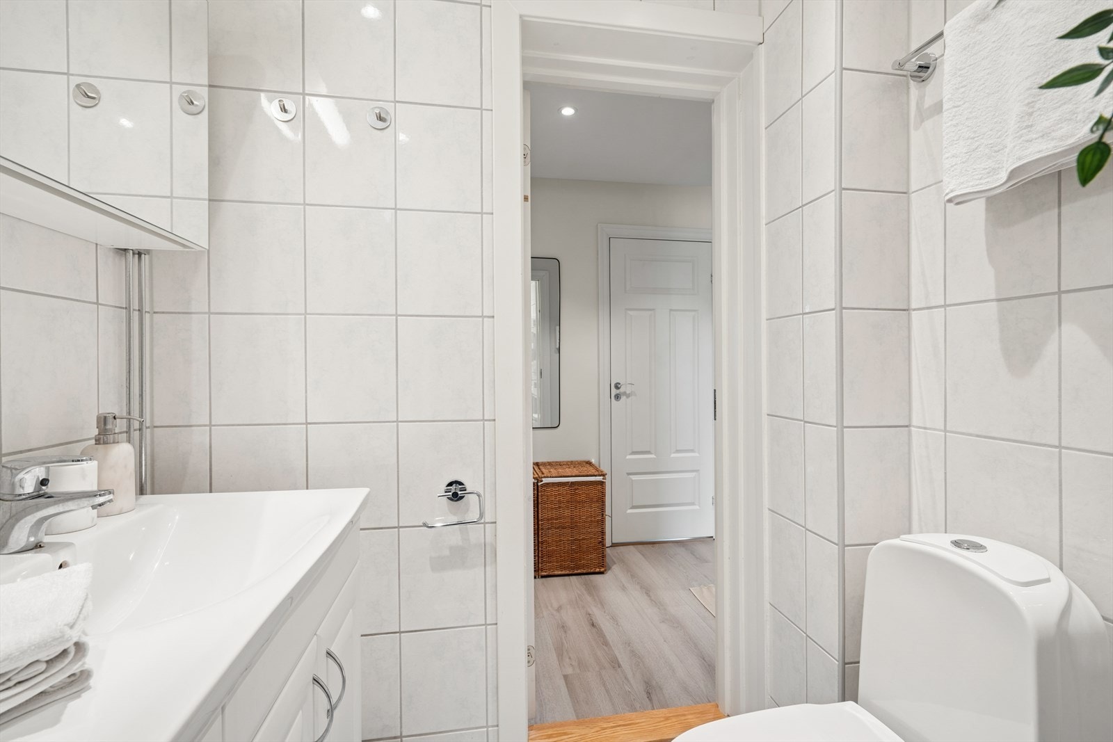 Baderommet er utstyrt med gulvstående toalett, dusjhjørne og servant med skuffer under. Vaskemaskin og tørketrommel medfølger handelen. Galleribilde