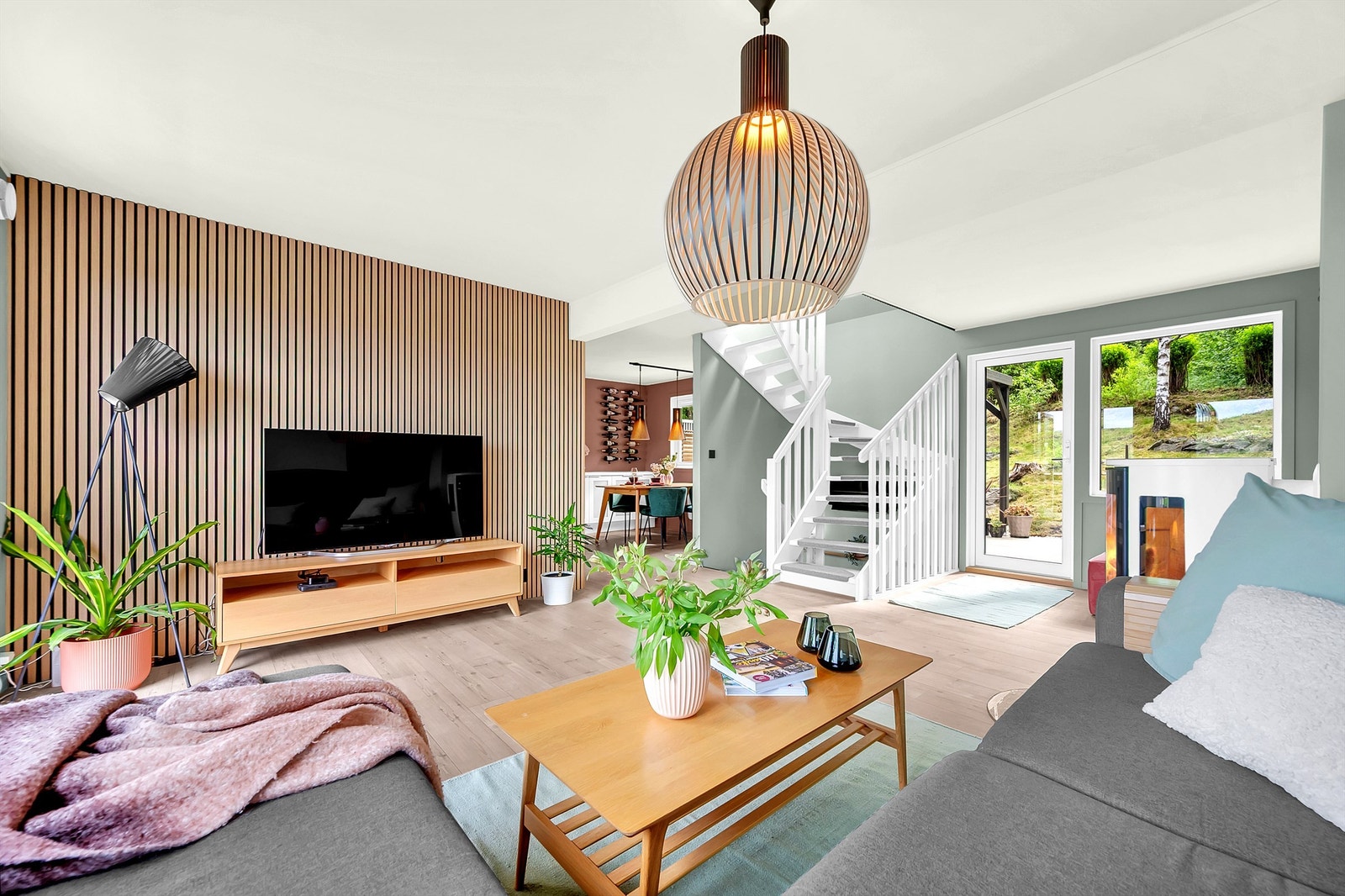 Romslig stue med nyere peisovn i delvis åpen løsning mot kjøkken. Galleribilde