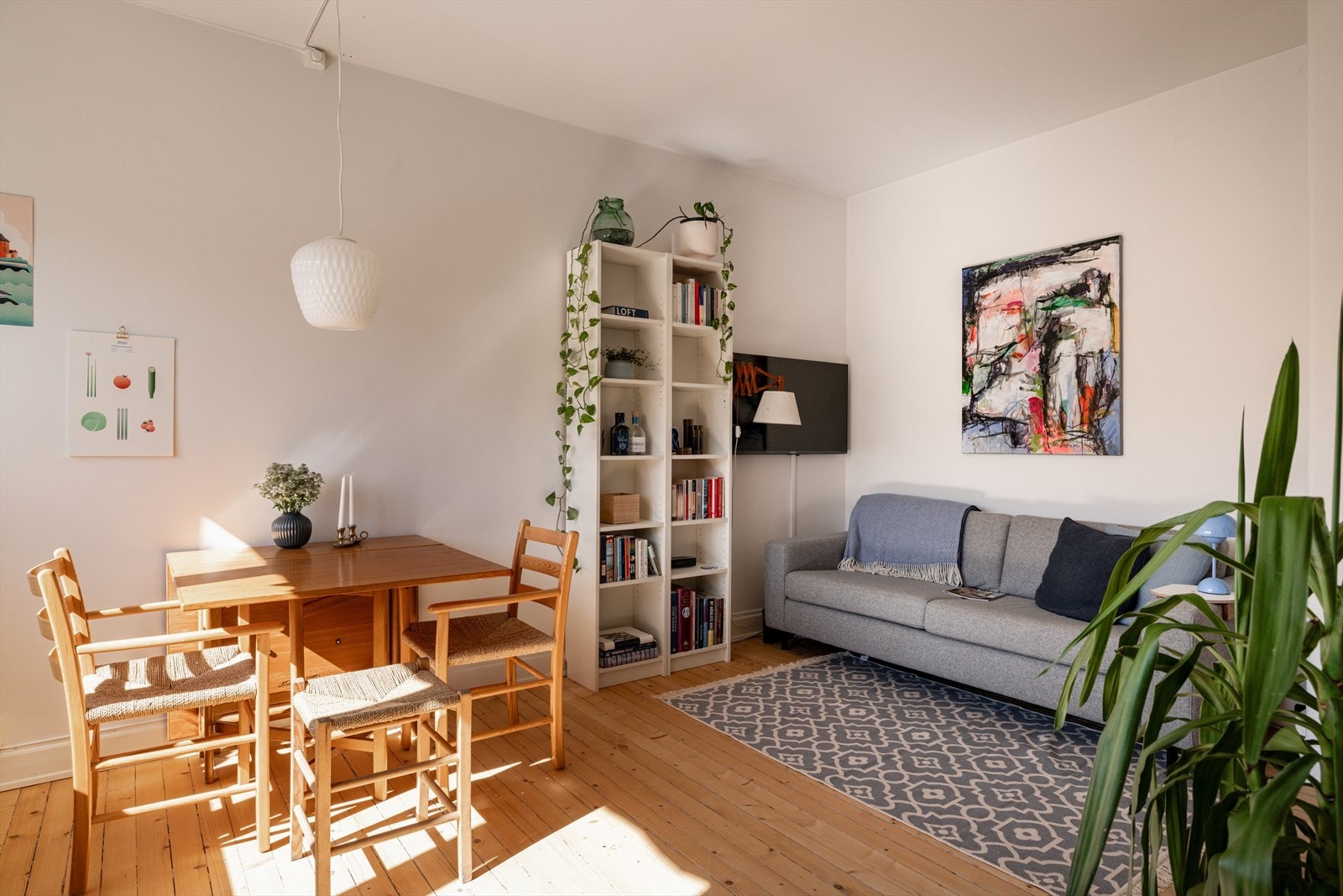 Lys stue malt i tidløse farger som står i stil med det lyse, originale tregulvet. Galleribilde