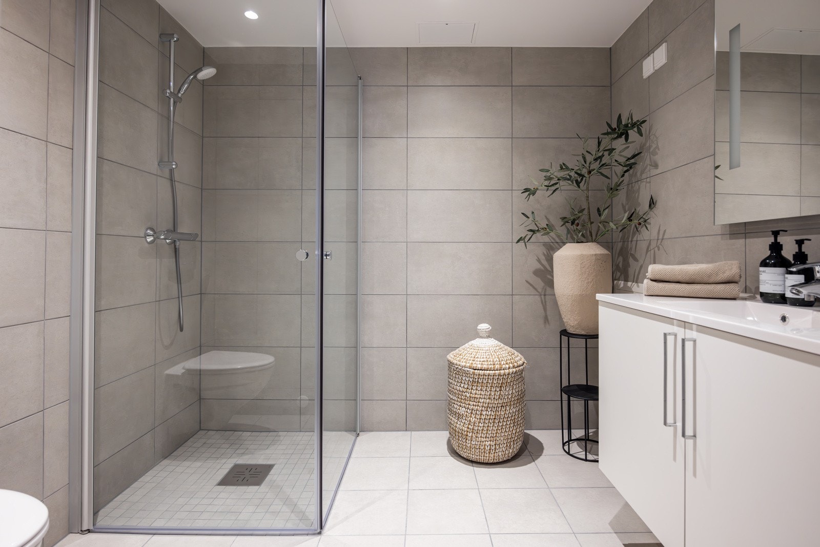 Smakfullt bad med flislagte overflater og varmekabler i gulv. Galleribilde