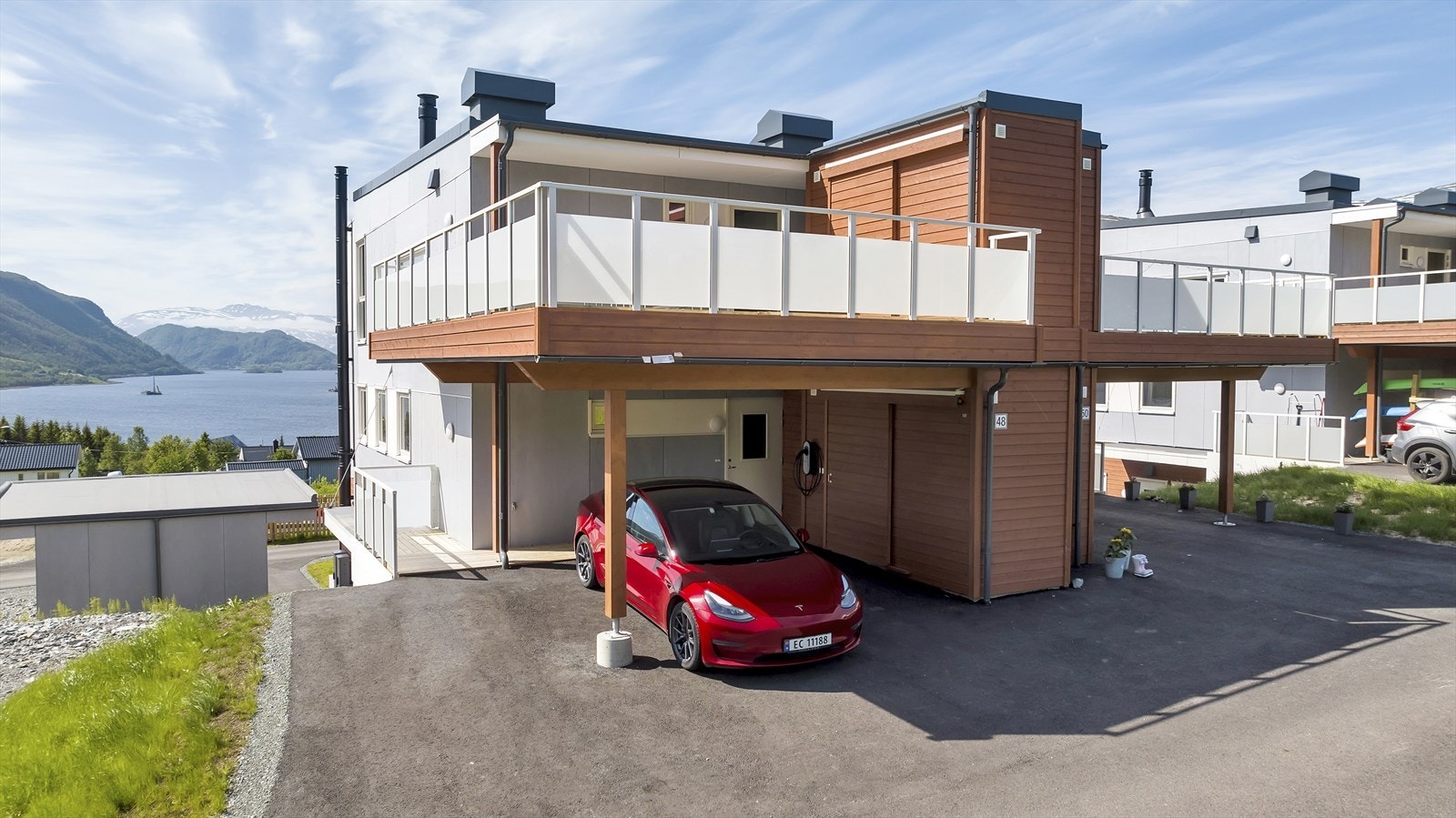Carport ved inngangspartiet, med fastmontert elbillader. Galleribilde