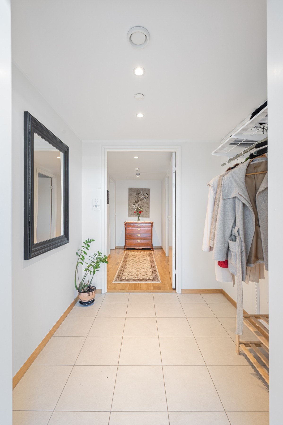 Flislagt og innbydende entré med smarte opphengsmuligheter Galleribilde