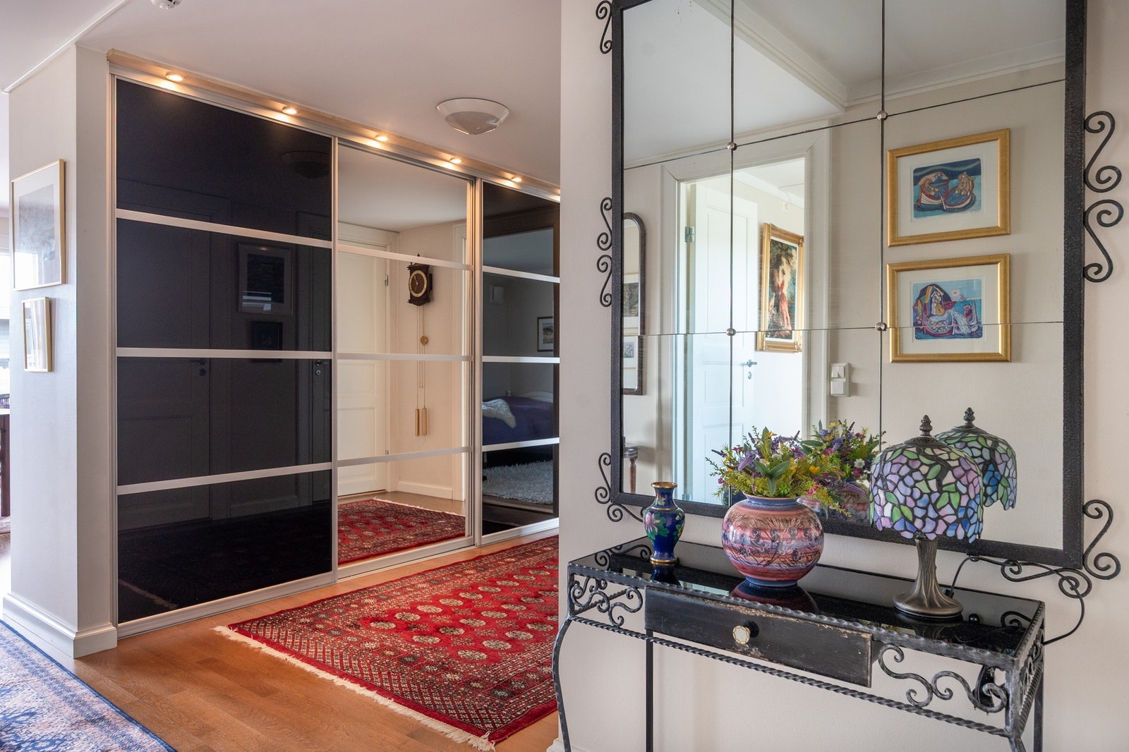 I hallen er det en stor skyvedørsgarderobe med speildør. Galleribilde