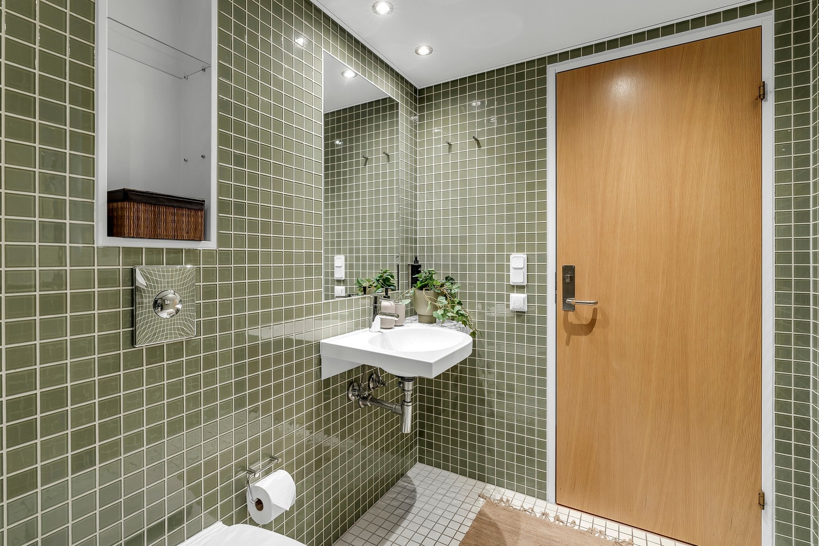 Innredning fra Grohe og speilfelt integrert i flisveggen fremhever den gjennomførte stilen. Galleribilde