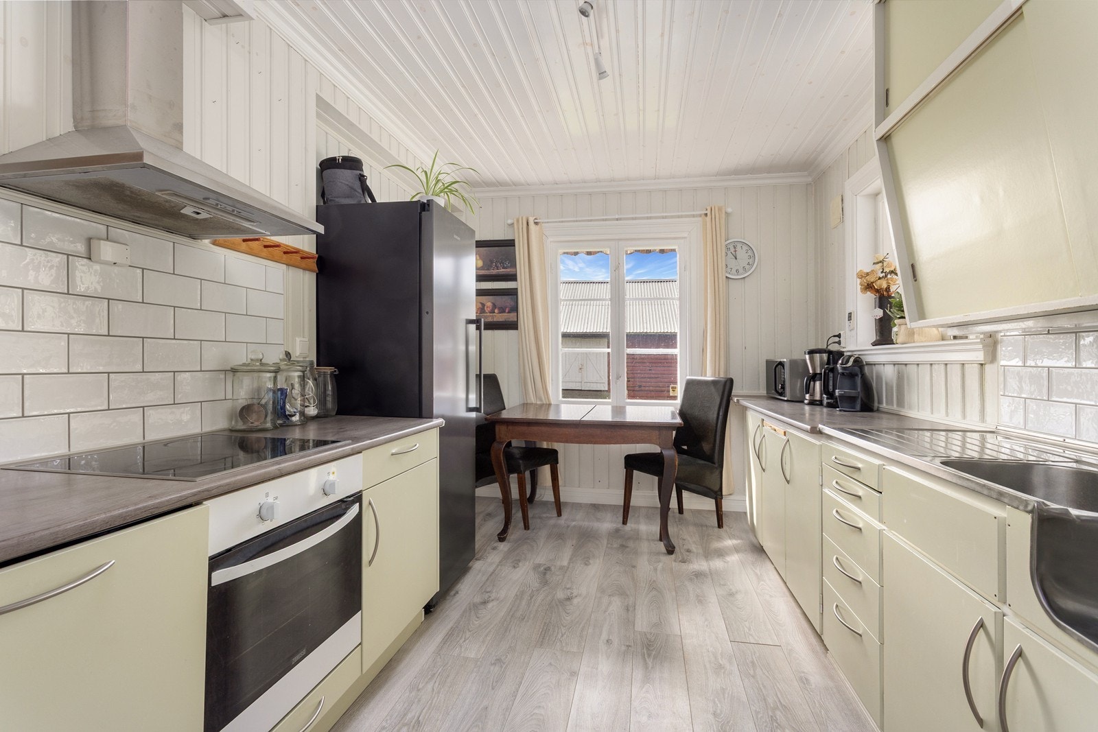 Kjøkkenet har klassisk innredning med malte fronter, laminat benkeplate og integrerte hvitevarer fra 2018. Galleribilde