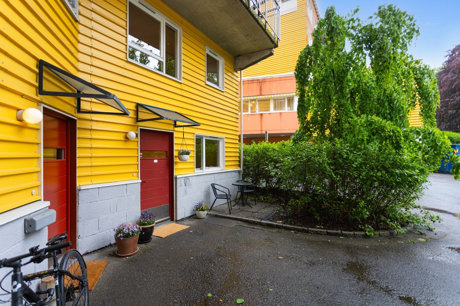 Leiligheten har trappefri egen inngang som gir rekkehusfølelse. Hyggelig sitteplass skjermet av et flott japansk hjertetre - Cercidiphyllum Japonicum. Galleribilde