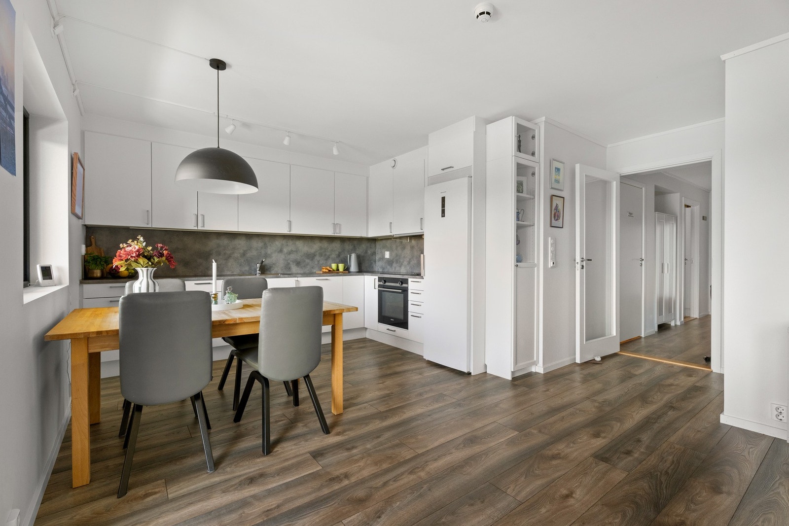 Stuen ligger i åpen løsning med kjøkkenet, og sammen danner de et luftig og innbydende allrom. Galleribilde