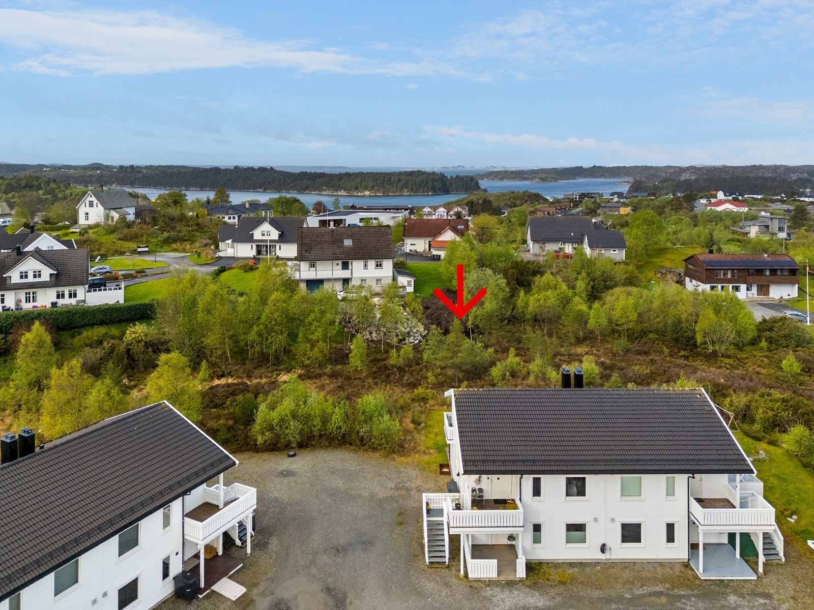 Tomten er relativt flat med vei frem til eiendomsgrensen. Galleribilde