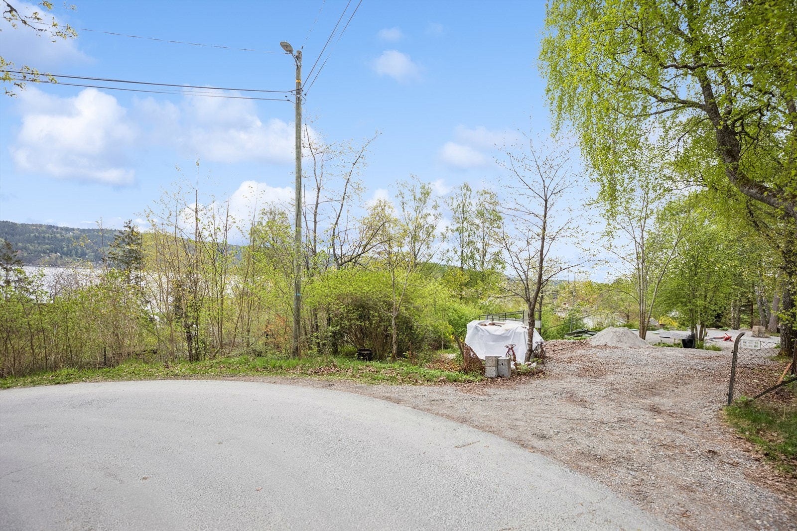 Det asfaltert bilvei frem til tomten. Galleribilde