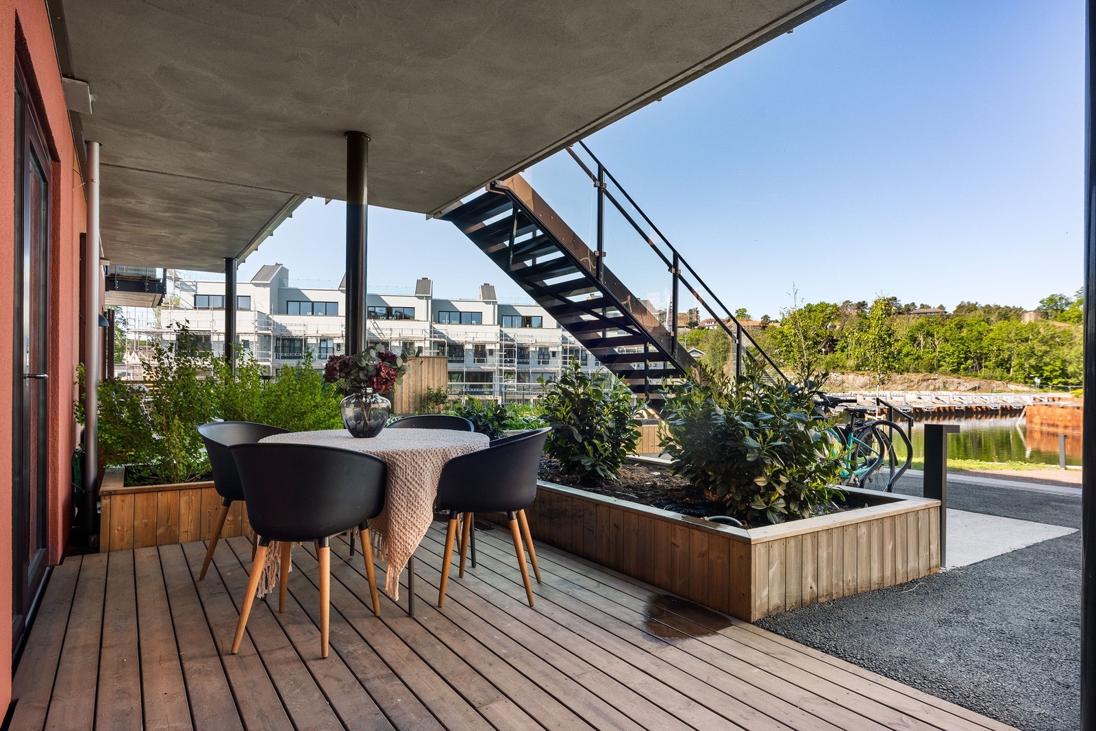 Stor platting ved inngangspartiet som gir god plass til møblering. Utsikt mot kanal. Galleribilde