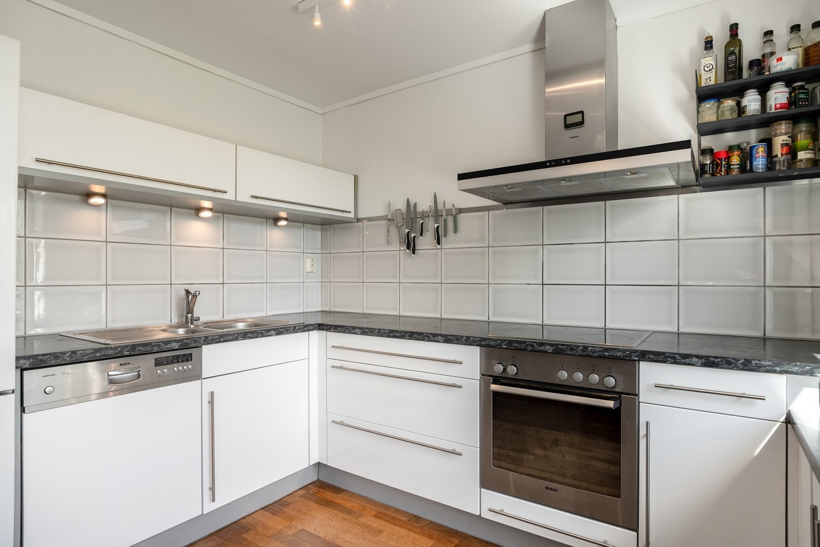 Kjøkkenet er stilrent med glatte fronter og laminert benkeplate. Galleribilde