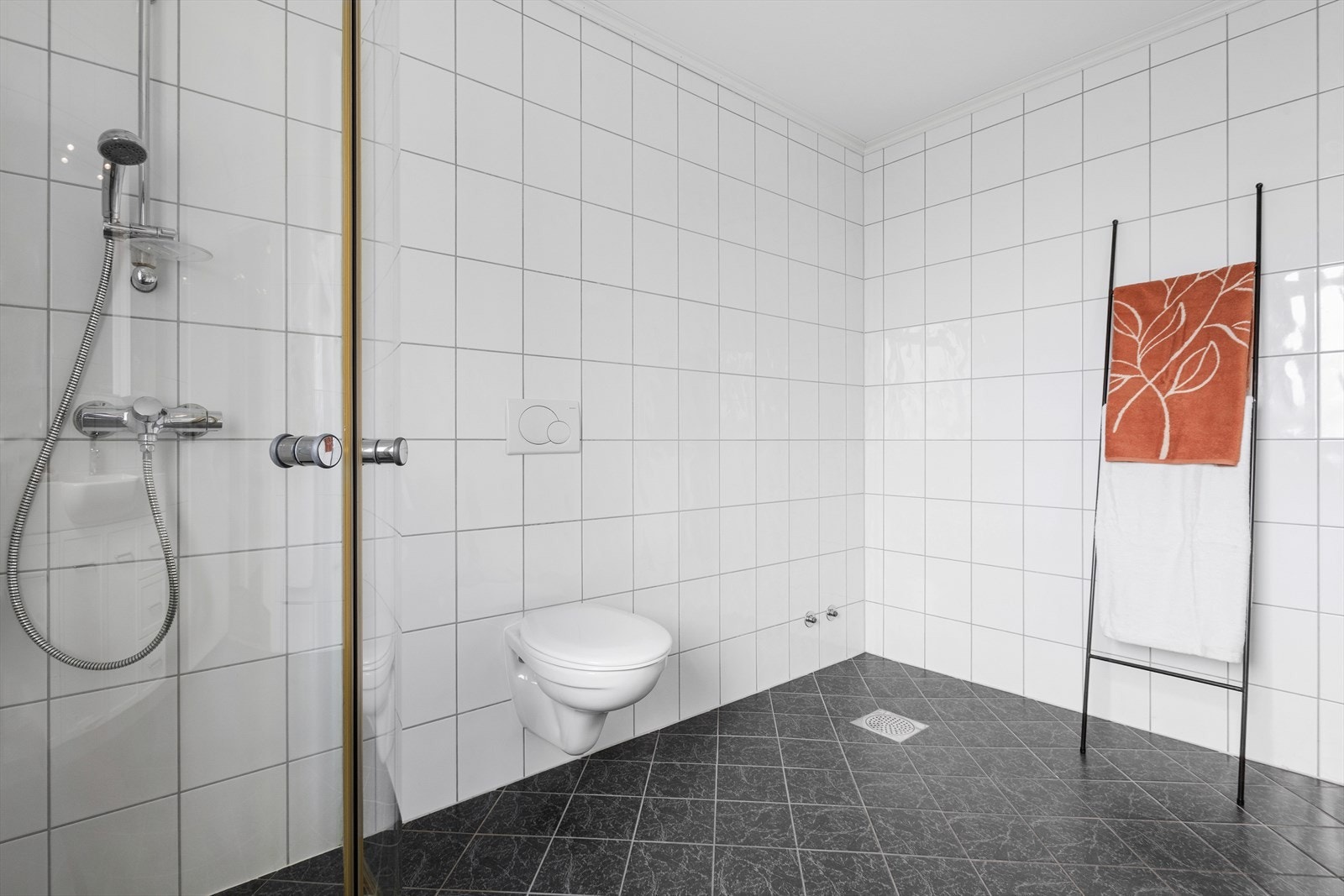 Flislagte overflater som gir eit stilreint og tidløst uttrykk. Merk også at det er klargjort for badekar i hjørnet Galleribilde