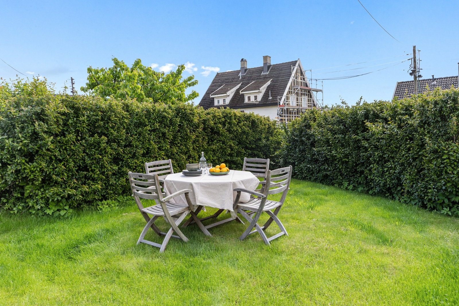 Tomten er anlagt med plenareal og dekorativ beplantning som rammer inn uteområdet på en tiltalende måte Galleribilde