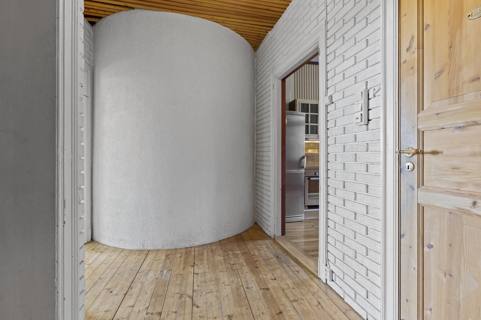 Tregulv, teglstein på vegger og malt panel i tak. Galleribilde