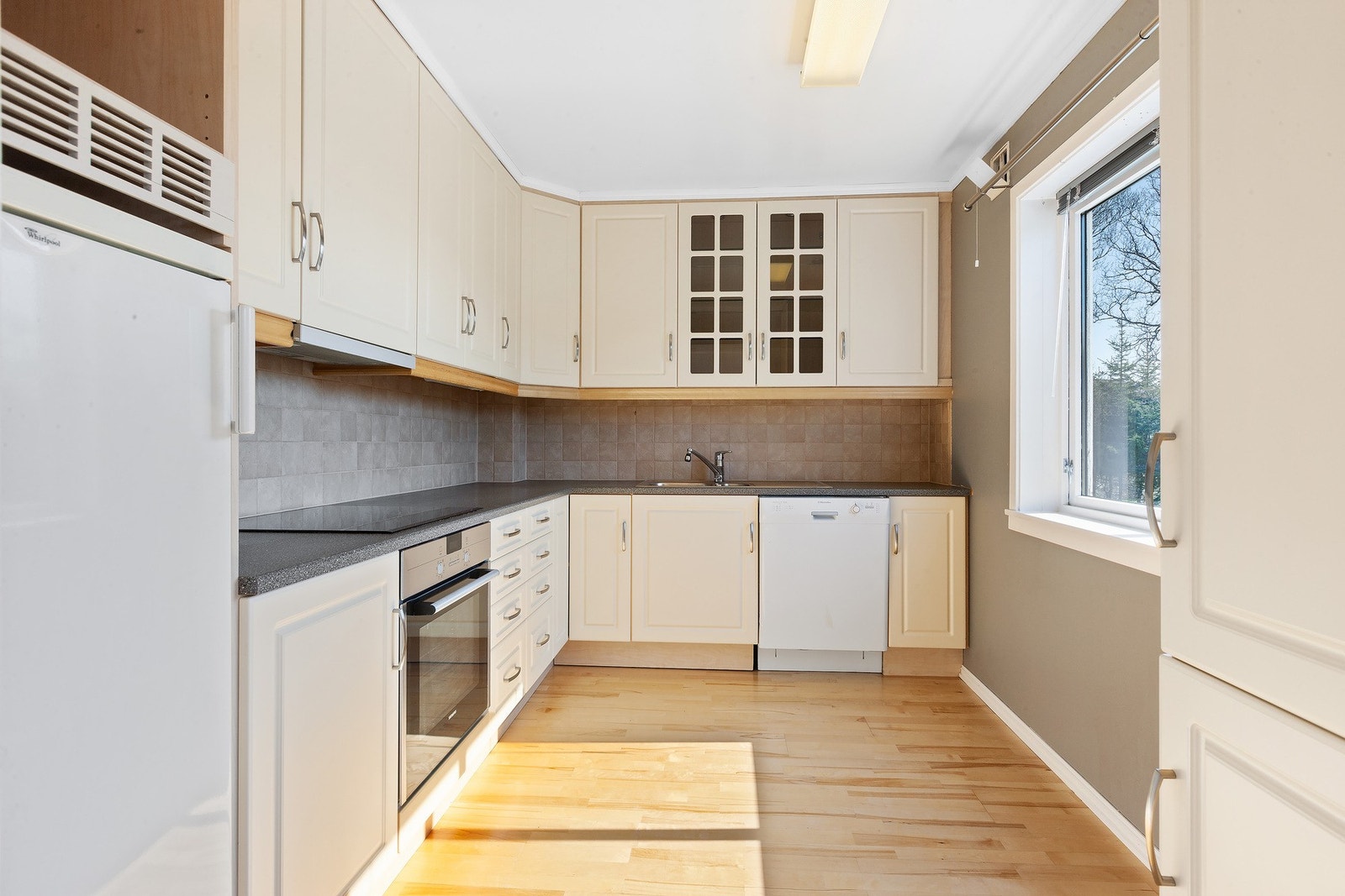 Kjøkken med lyse fronter og god benkeplass. Galleribilde