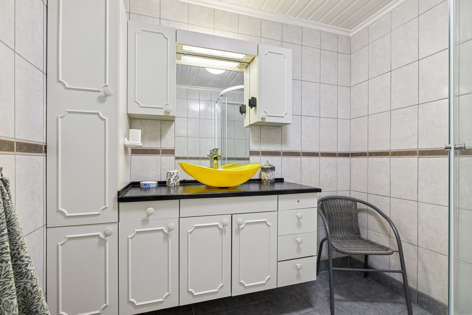 Badet er av eldre dato og har flislagte overflater med varmekabler i gulvet. Galleribilde