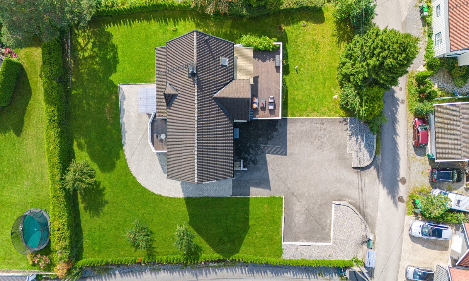 Her har du god plass til flere biler med asfaltert gårdsplass. Det er steinbelagt passasje til inngangen. Galleribilde