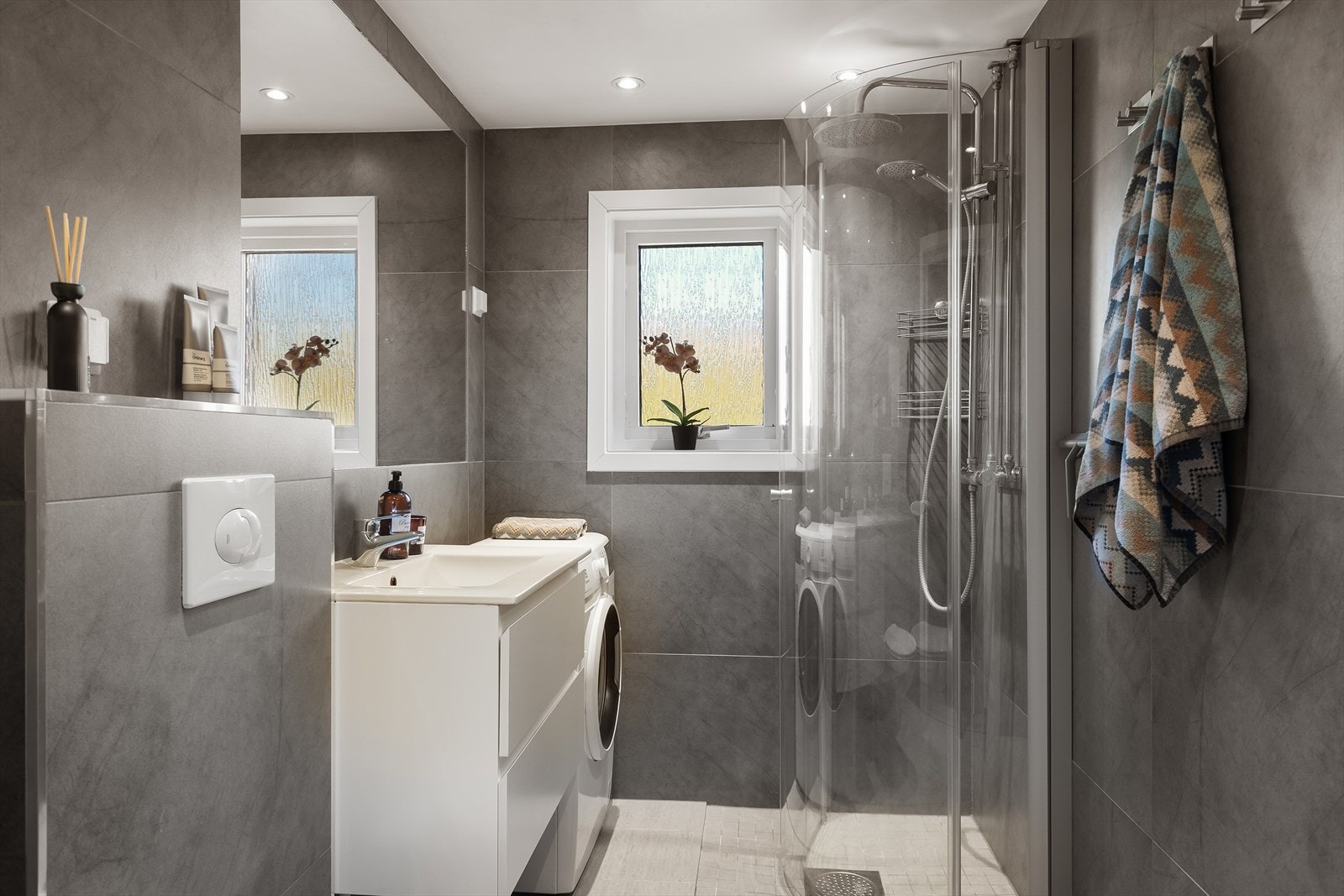 Pent og moderne flislagt bad fra 2018 med opplegg for vaskemaskin (smal type). Galleribilde