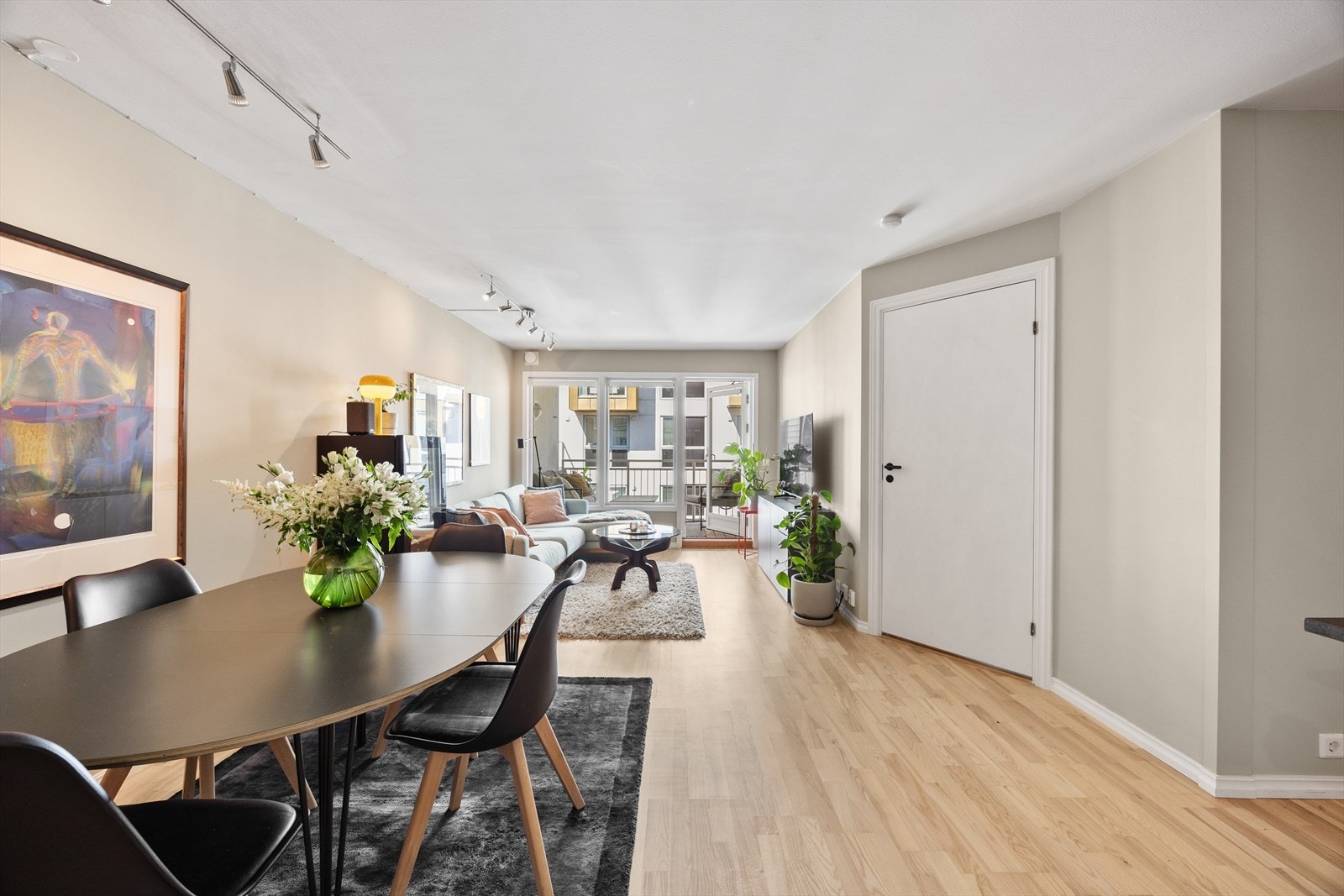 Lys stue med åpen løsning og direkte adgang til balkong. Galleribilde