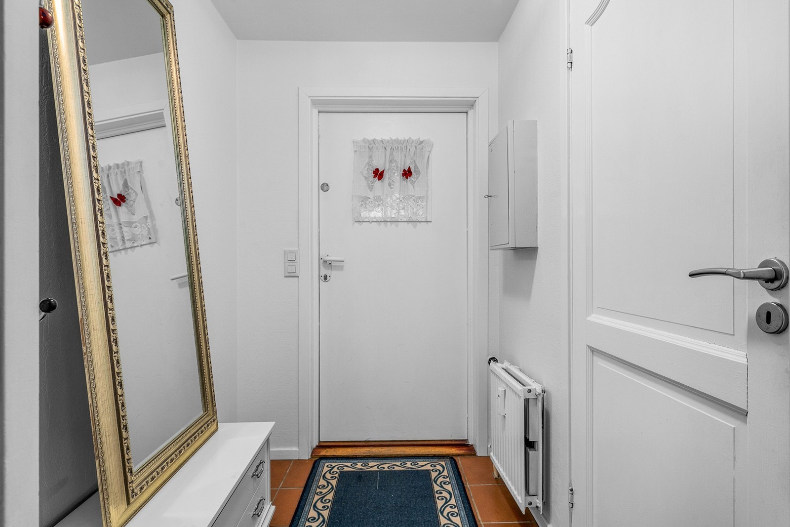 Lys og innbydende entré som gir et moderne førsteinntrykk av boligen. Her er det god plass til oppbevaring av yttertøy og sko, og rommet fungerer som et praktisk knutepunkt mot øvrige deler av boligen Galleribilde