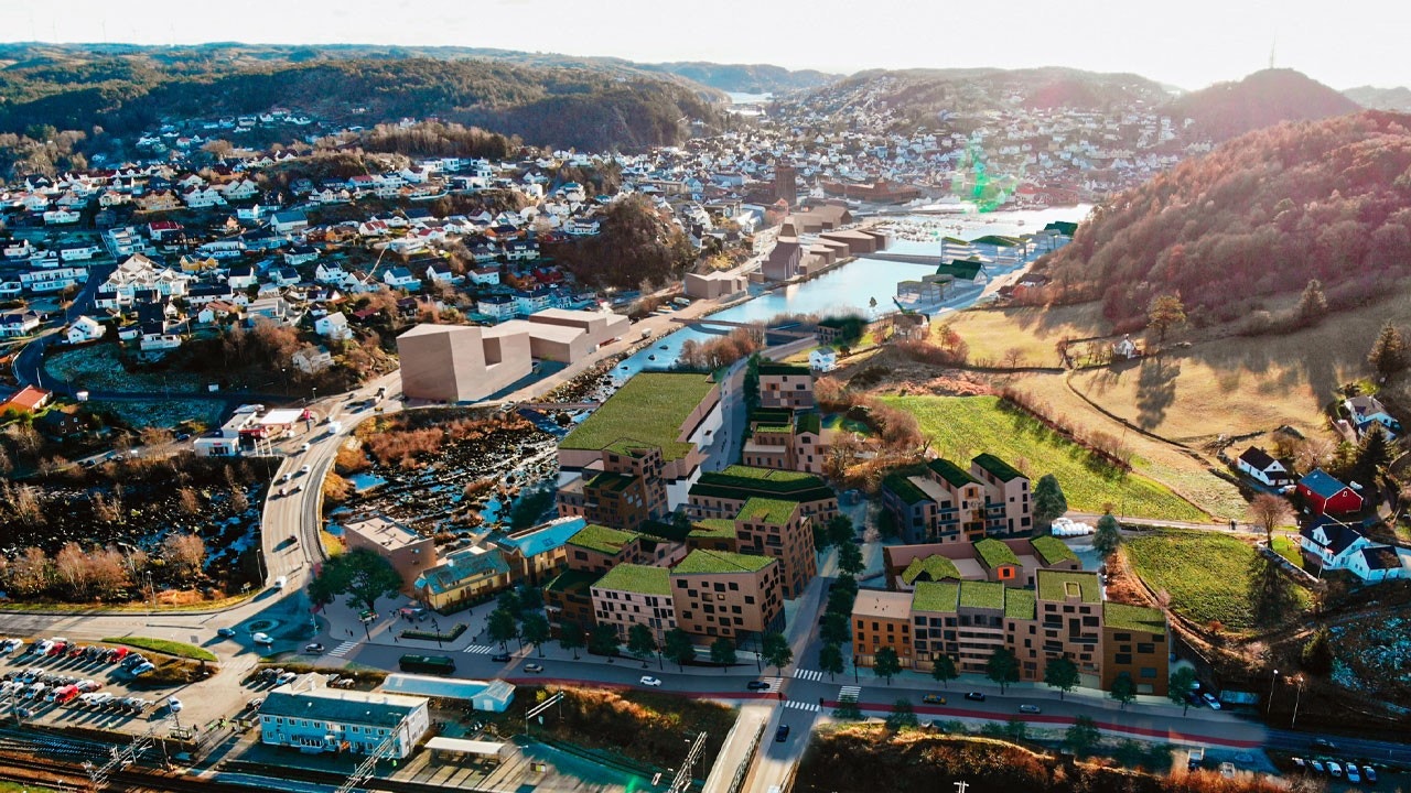 Illustrasjon av hvordan den nye bydelsen og området rundt kan bli seende ut. Dette ble laget før det ble aktuelt med ny videregående skole her. Galleribilde