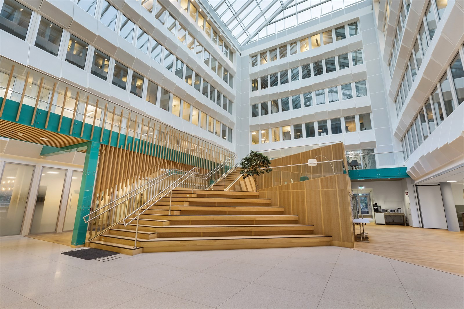 Lyst og flott atrium med sosiale soner.