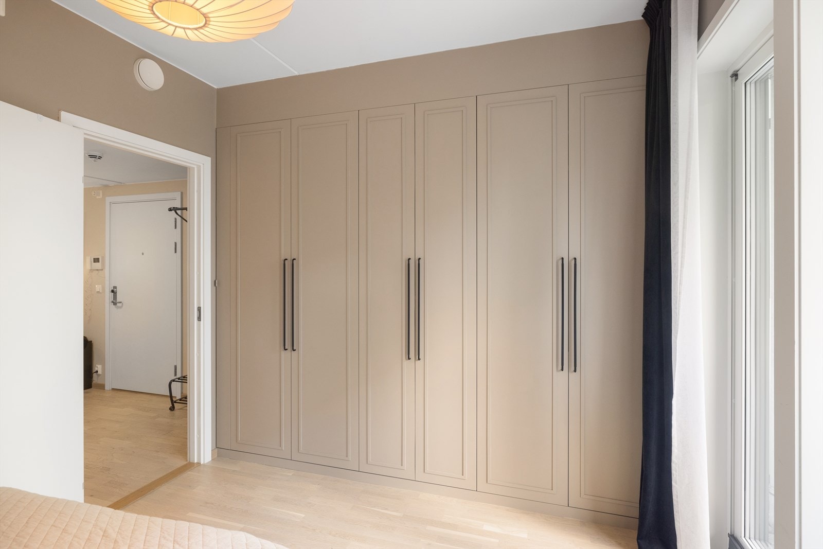 Rommet har en smart integrert garderobeløsning med pene og elegante fronter fra 2024. Galleribilde