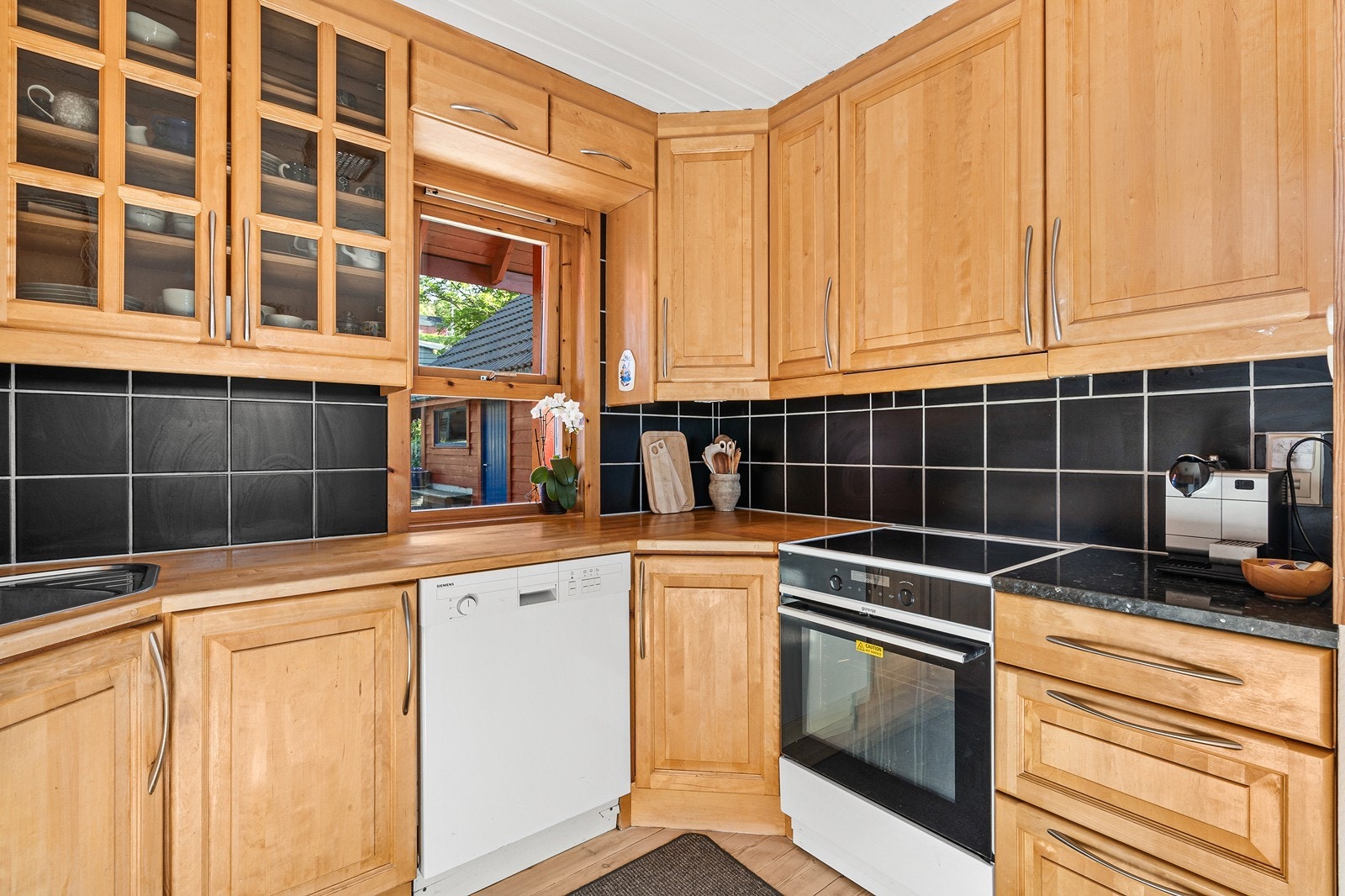 Kjøkkenet har innredning med profilerte fronter og benkeplate i tre. Galleribilde