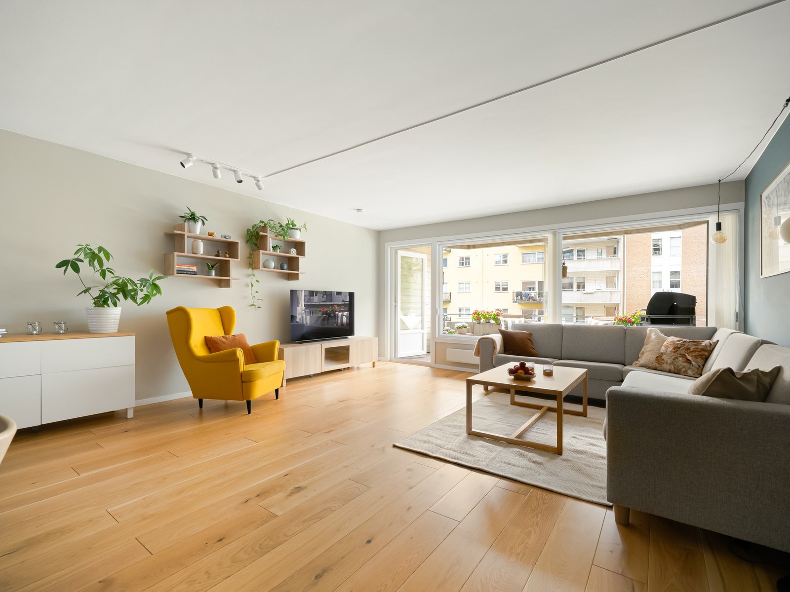 Vi begynner i stuen, et rom med store vinduer med dype karmer, flott tregulv og utgang til balkong. Galleribilde