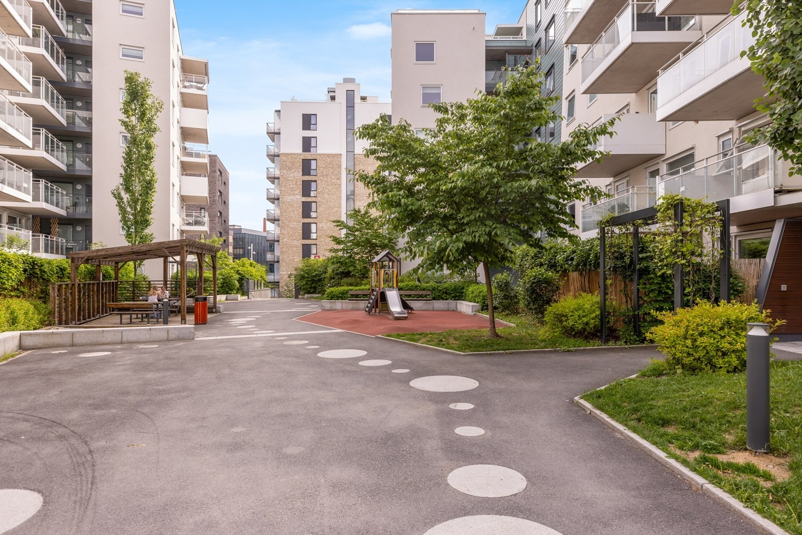 Fellesarealene er pent opparbeidet med prydbusker, beplantning, plen og asfalterte stikkveier til innganger. Galleribilde