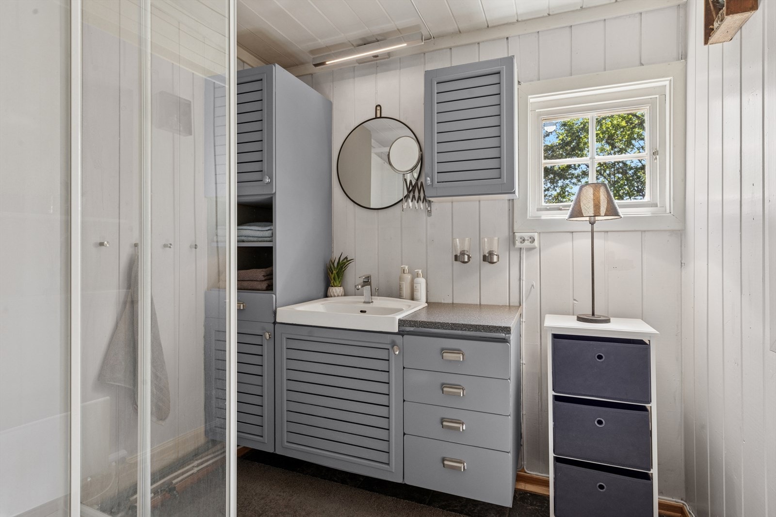 Bad innredet med baderomsinnredning og dusjkabinett. Galleribilde