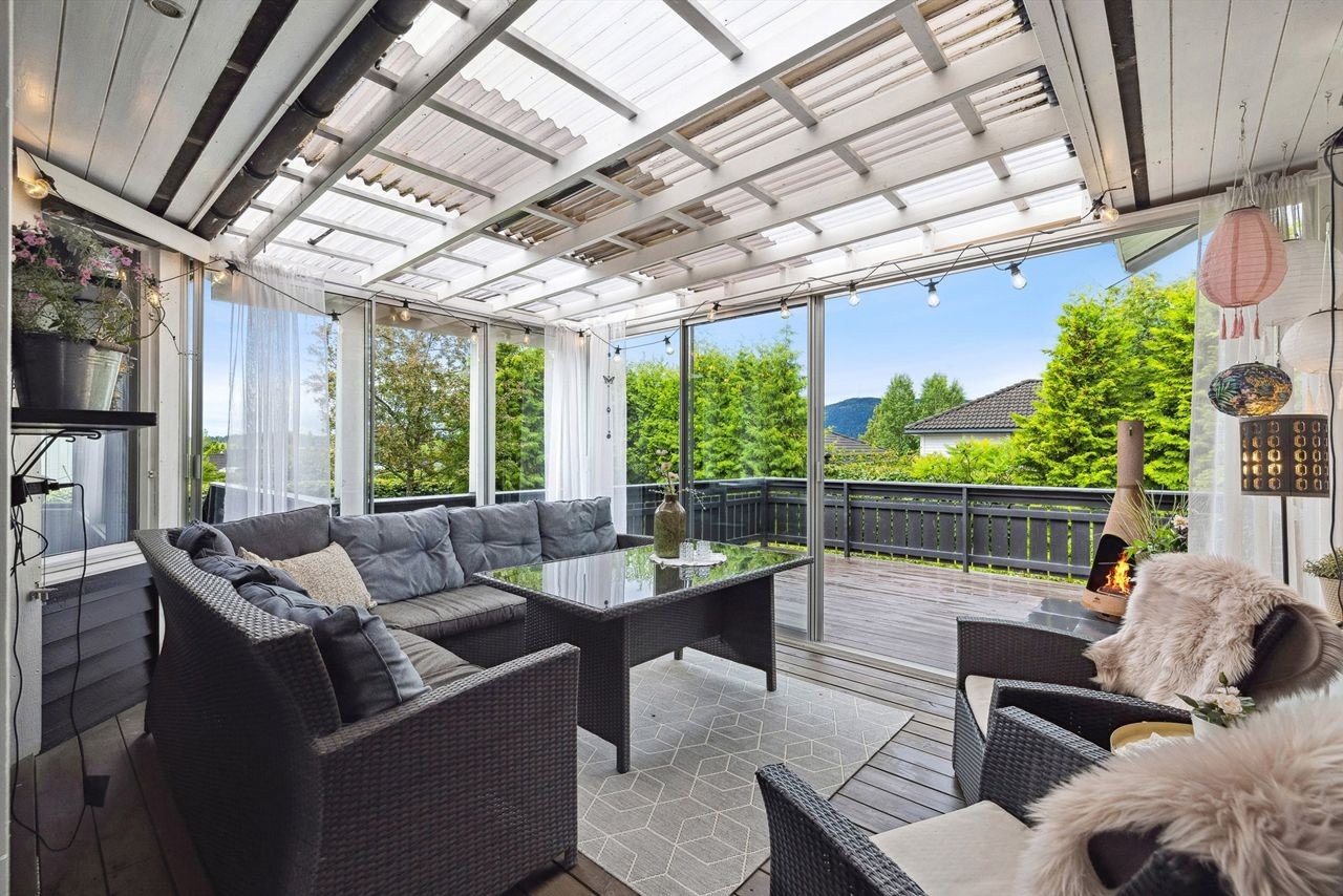 Deler av terrassen er glasset inn til flott og hyggelig sommerstue. Galleribilde