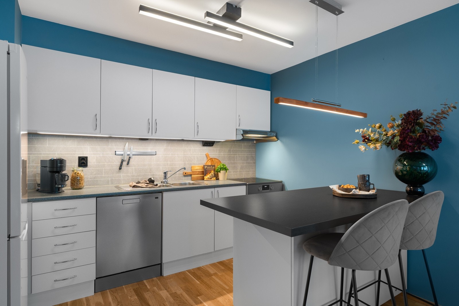 Kjøkkenet har en hvit innredning med godt med skap- og benkeplass. Galleribilde