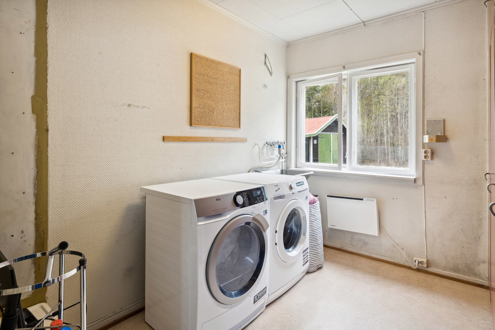 Arbeidsrom med tapet på veggene og belegg på gulvet. Rommet er pr dags dato benyttet som vaskerom med utslagsvask montert på vegg med opplegg for vaskemaskin. Rommet har ikke sluk og kan derfor ikke kvalifiseres som vaskerom. Galleribilde