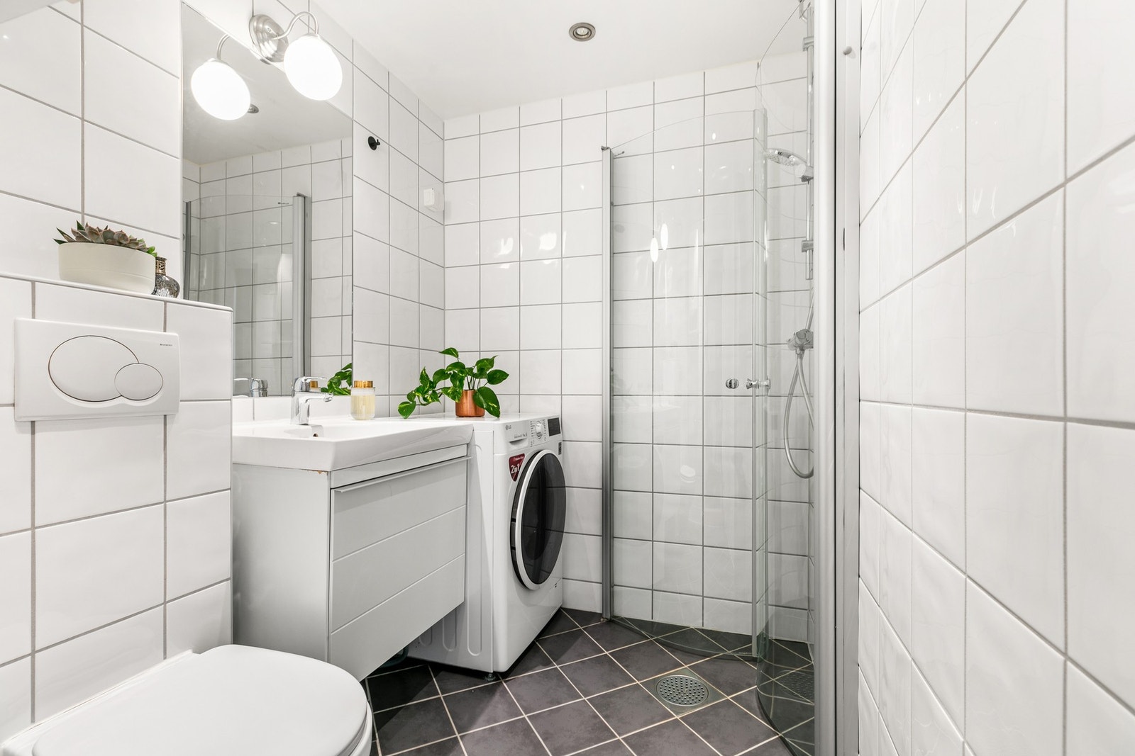 Pent flislagt bad fra 2008 med gulvvarme, dusjhjørne, vegghengt toalett og opplegg for vaskemaskin. Galleribilde