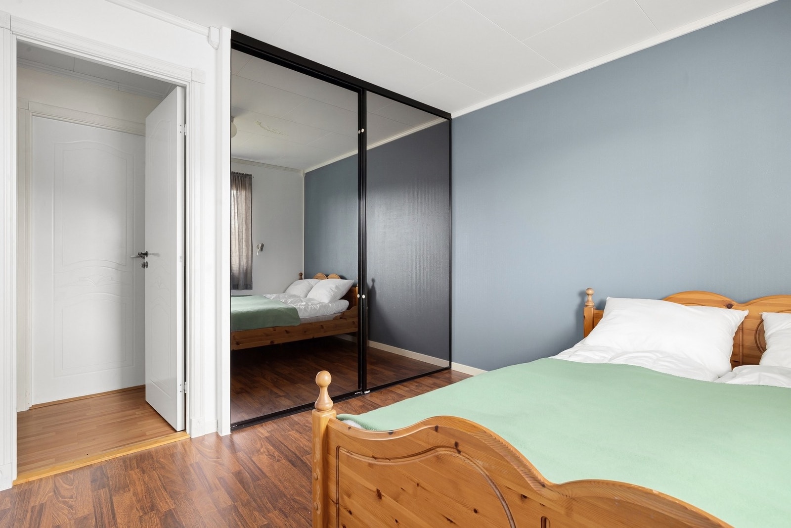 Velkommen inn på hovedsoverommet, som også byr på skyvedørsgarderobe Galleribilde