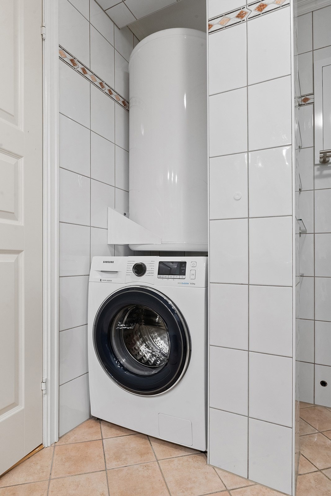 På badet er det opplegg for vaskemaskin. Varmtvannsberederen er plassert opp fra gulvet like over vaskemaskinen. Galleribilde