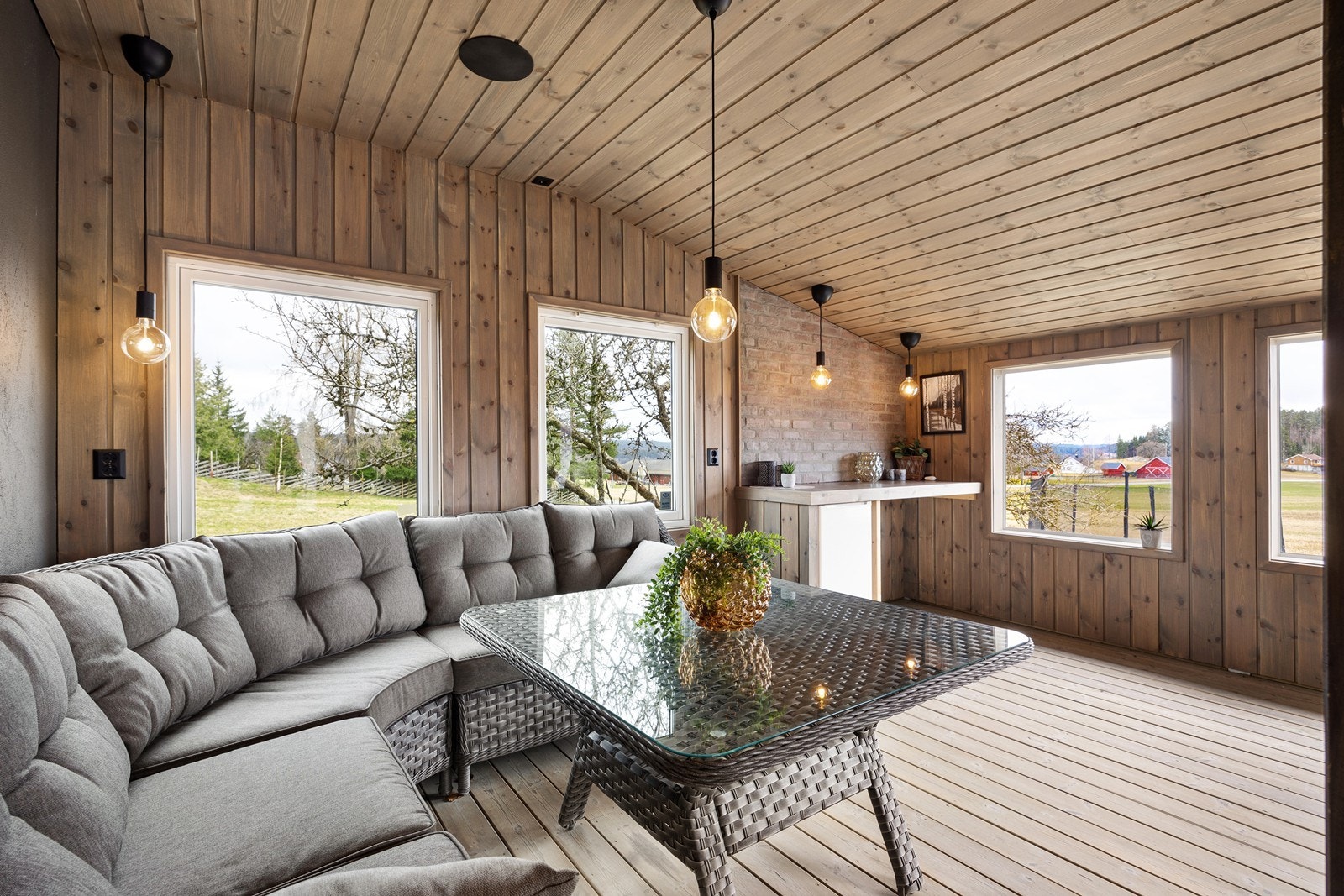 I underetasjen er det en trivelig overbygget terrasse som er kledd med vegger og vindu. Galleribilde