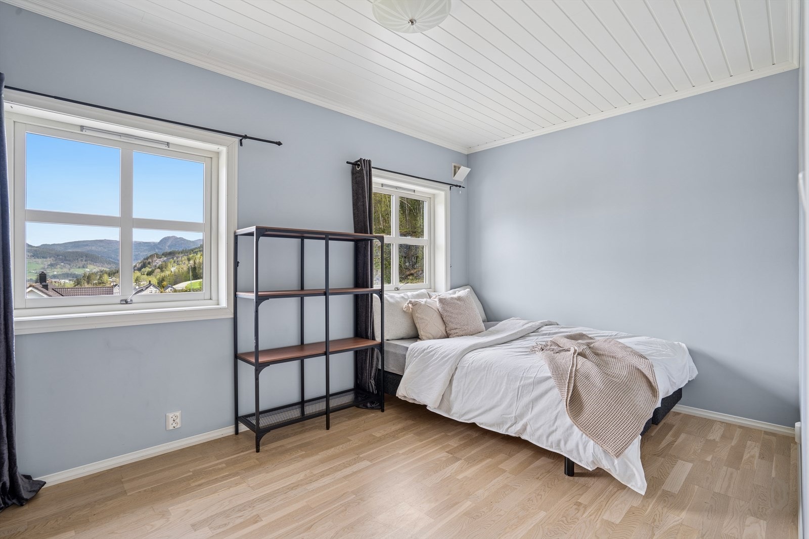 Det som i dag brukes som gjesterom har to store vinduer, skyvedørsgarderobe og god plass til møblering! Galleribilde