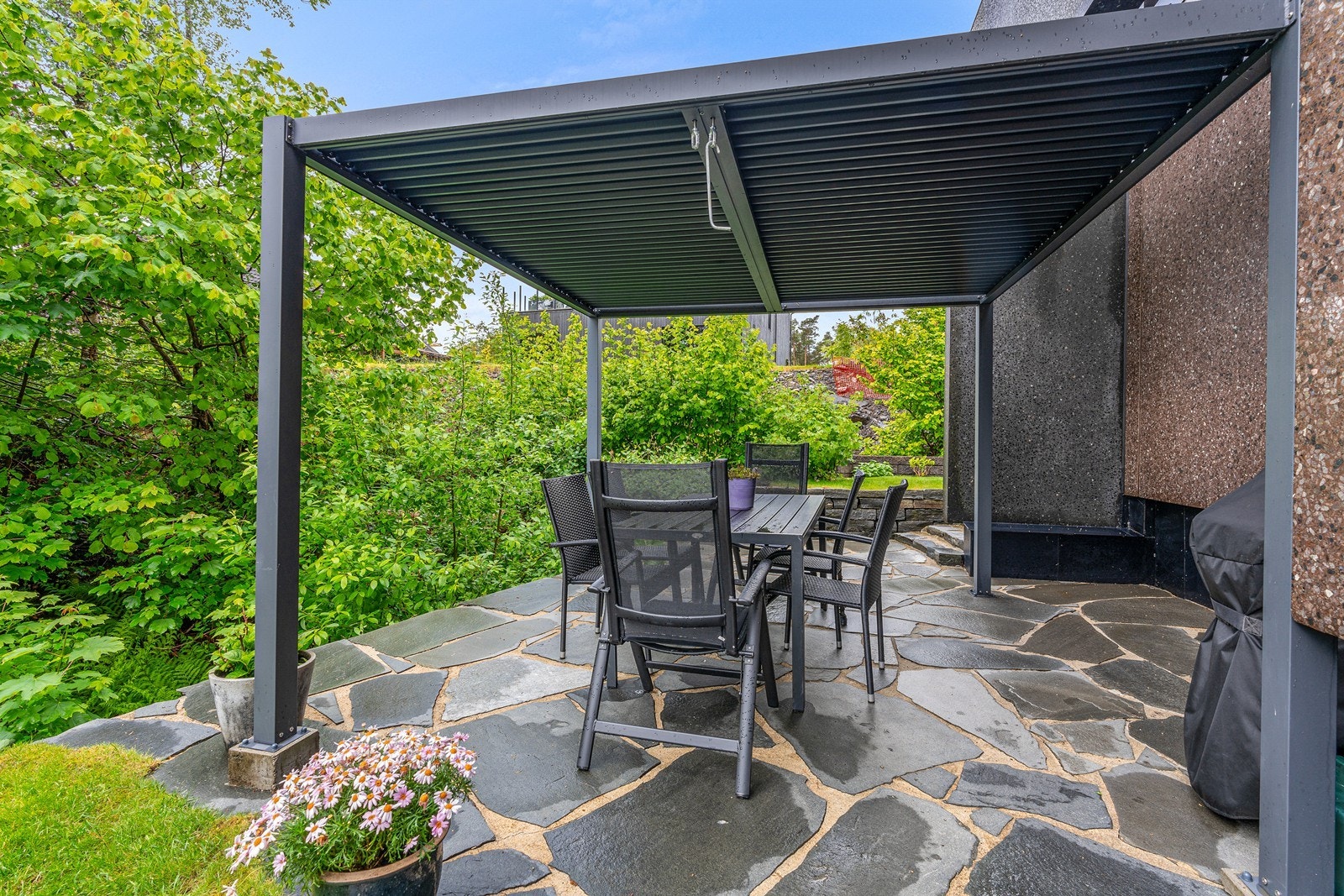 Flott opparbeidet uteplass med skiferstien, pergola, plass til spisegruppe og grill. Galleribilde