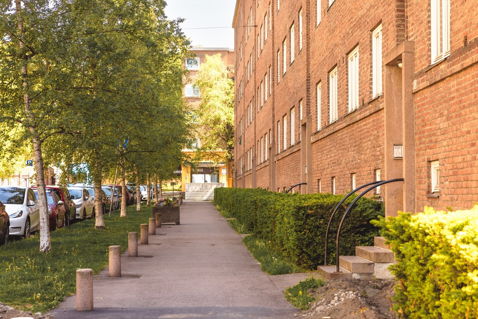 Uteområdene er pent opparbeidet med gressplen, beplantning, trær og interne stikkveier til innganger. Galleribilde