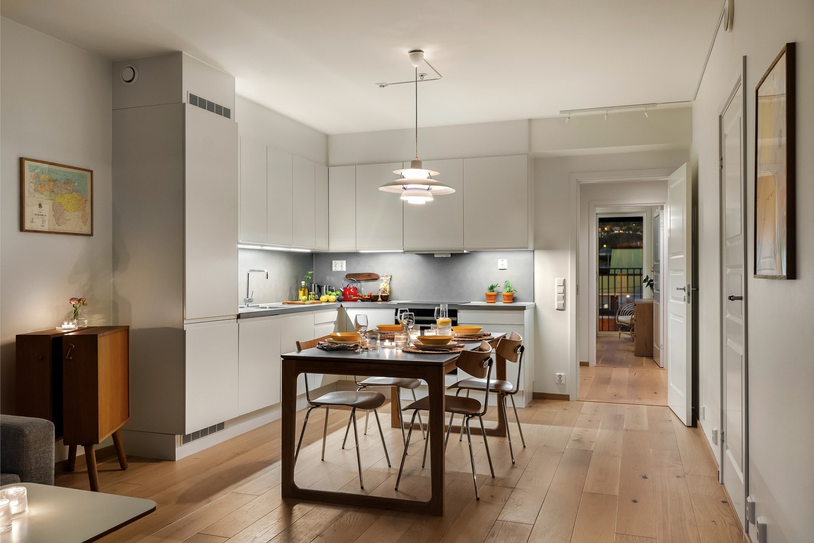 Den åpne løsningen mellom kjøkken og stue skaper et naturlig samlingspunkt for både hverdagsliv og sosiale anledninger. Galleribilde