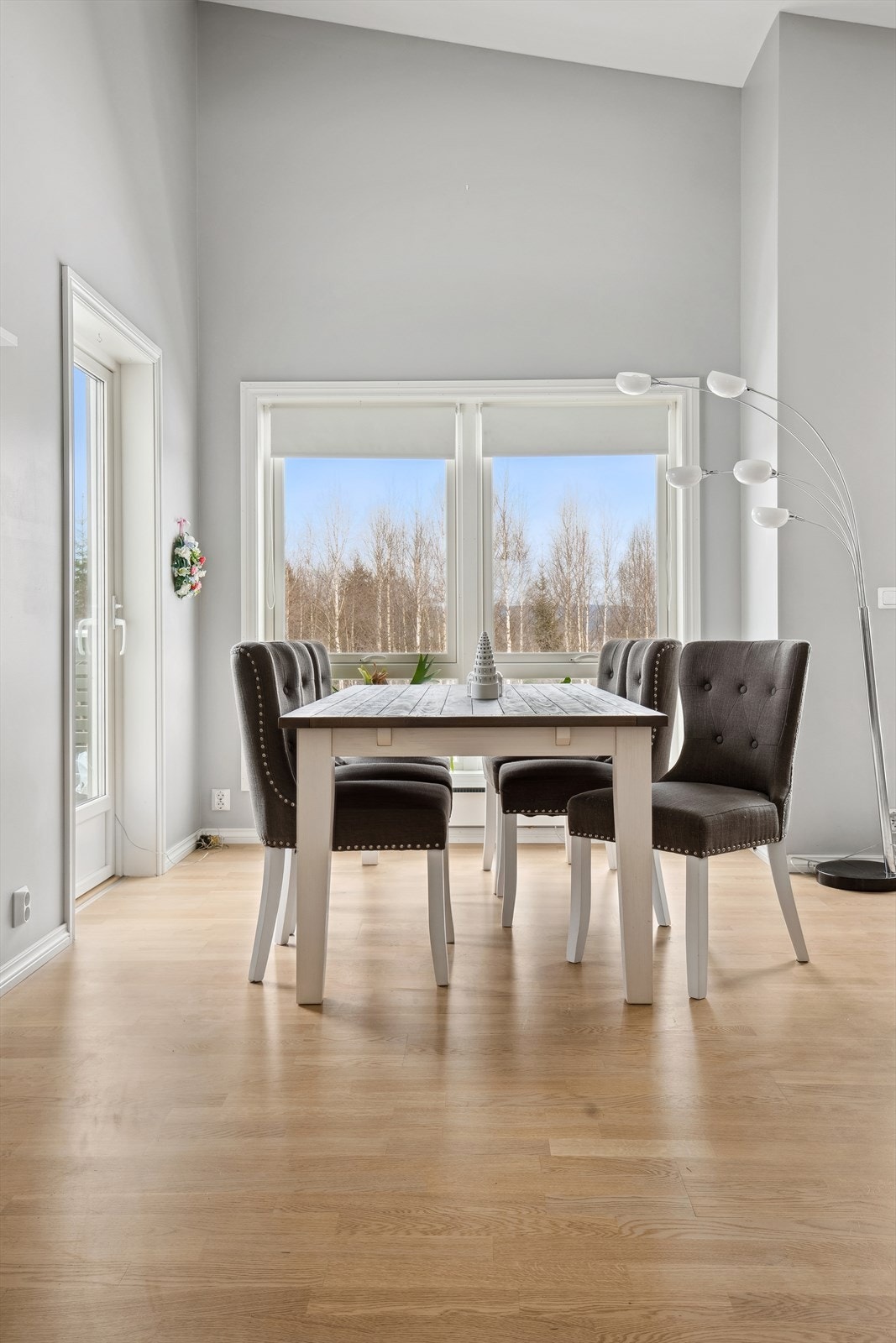 Stuen har lysmalte vegger og parkett på gulvet. Flere vinduer på forskjellige vegger slipper inn godt med dagslys. Galleribilde