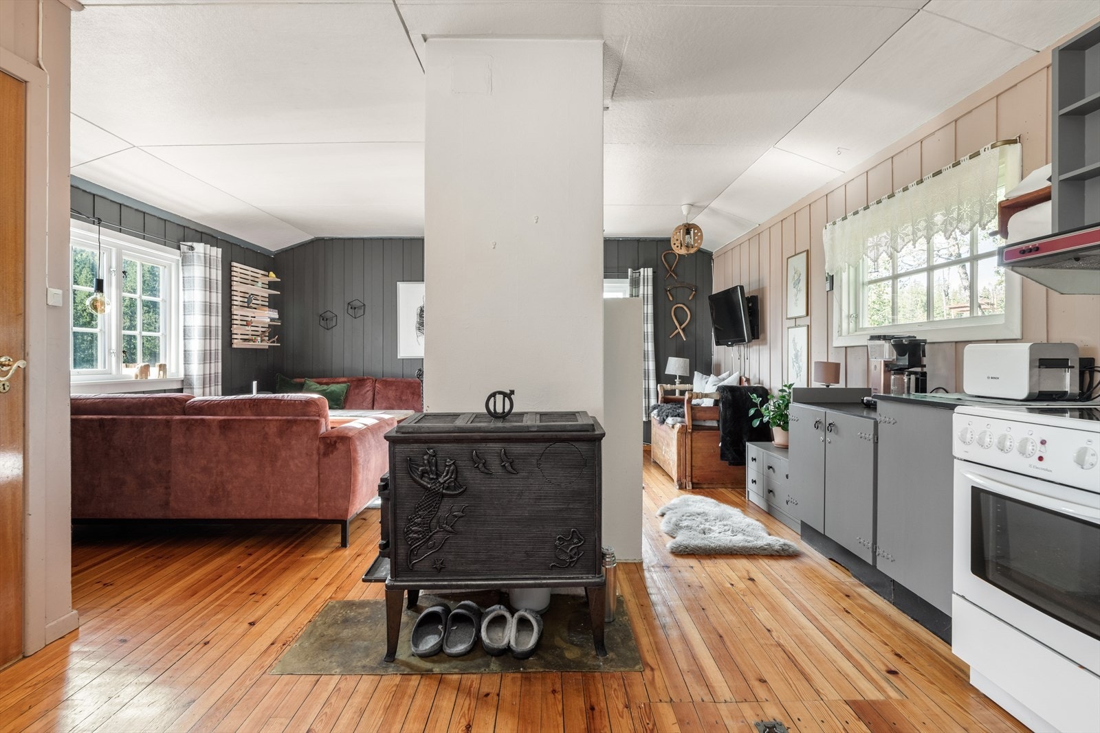I stuen er det både vedovn og åpen peis for lun varme på kaldere dager. Galleribilde