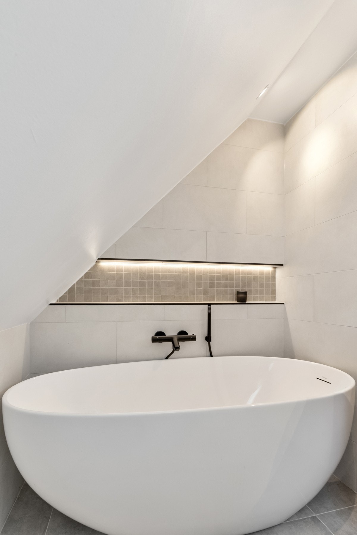 Delikat, flislagt baderom med både badekar og dusj Galleribilde