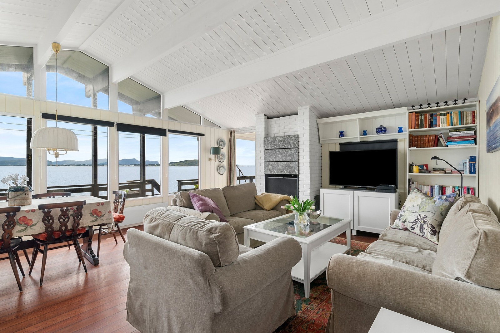 Stuen preges av god takhøyde og panoramavinduer som skaper en lys og behagelig atmosfære. Hytten varmes opp med vedfyring. Galleribilde