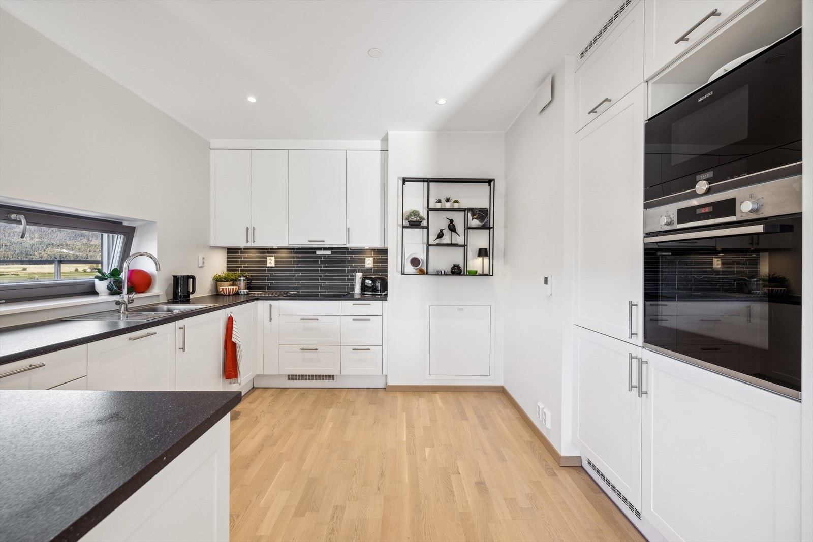 Kjøkkenet har integrerte hvitevarer bestående av kjøle/fryseskap, oppvaskmaskin, stekeovn, micro og induksjonstopp. Galleribilde