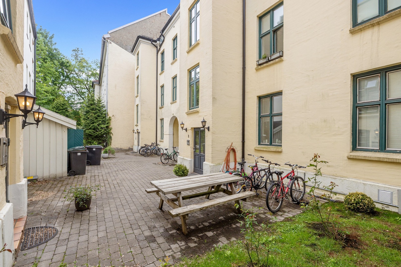 Bakgården har sykkelparkering og sittebenker. Galleribilde