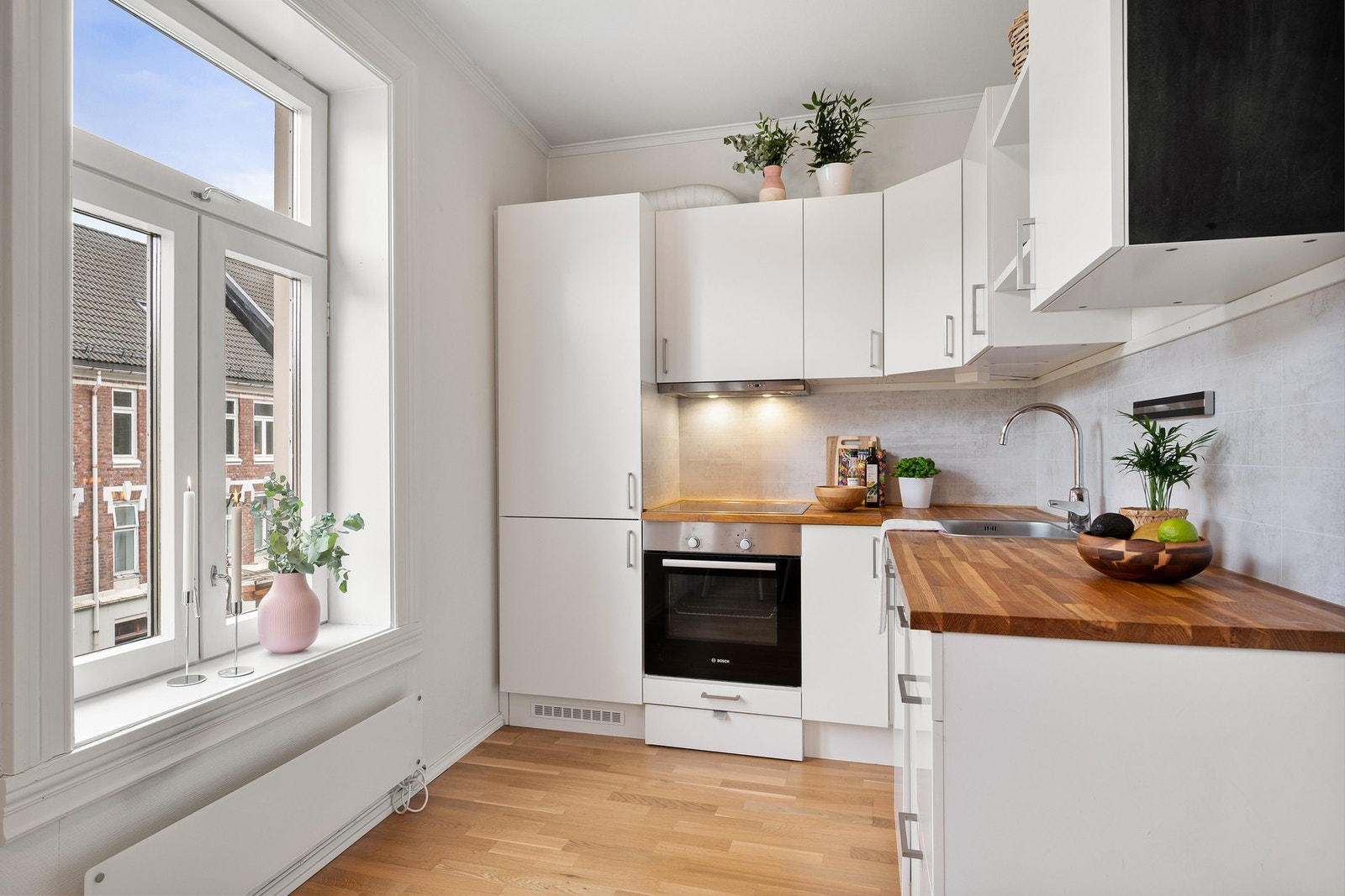 Stilrent kjøkken med glatte fronter og heltre benkeplate. Galleribilde